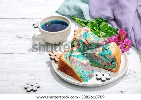 Apple pie in unicorn colors ready to eat. Homemade baking, nostalgic food. Hard light, dark shadow, white wooden background, copy space