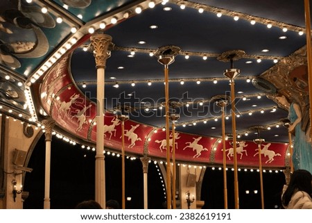 Merry go round carousel light in an amusement park in night Royalty-Free Stock Photo #2382619191