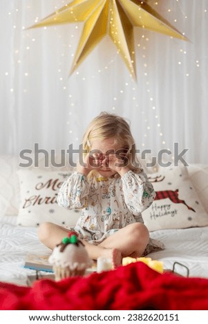 Little blond toddler child, girl, crying in bed, not having gift for Christmas, sad picture