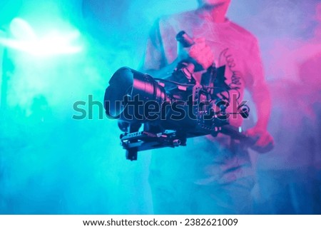 Cameraman shooting content with professional camera Royalty-Free Stock Photo #2382621009
