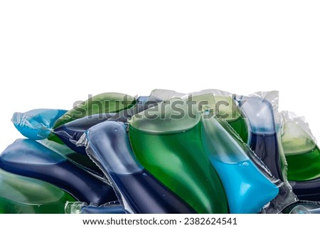 Colorful capsules with washing powder. A pile of several washing capsules rotates. Tablets for washing.