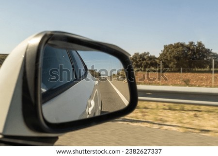 road with car driving on a sunny day and with traffic signs
