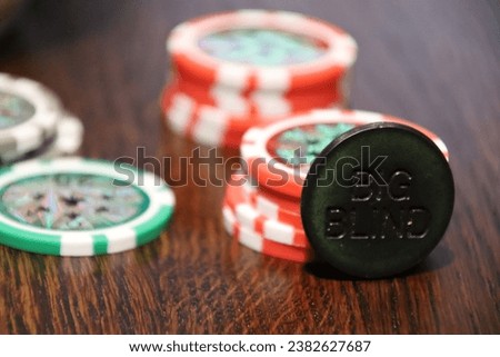 chips for playing poker and playing cards. A combination of poker chips and a dealer dealer in the foreground. Card poker hand-winning combination