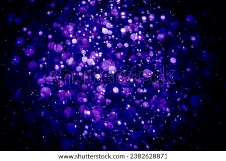Blurred photo with purple violet and blue dots visible glittering, shining brightly look and feel luxurious Suitable for use as a wallpaper