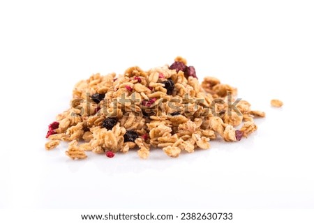 Muesli cereals close up with  raisins, oat and wheat flakes, fruits, strawberry, cranberry, cherry pieces. Isolated on white Royalty-Free Stock Photo #2382630733