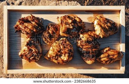 A Picture-Perfect Day for Savoring BBQ Chicken on a Wooden Plank, Bathed in Sunlight's Warm Glow
