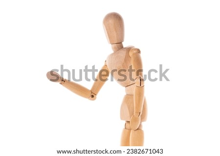 A wooden mannequin standing in front of a white background. This versatile image can be used for various purposes.