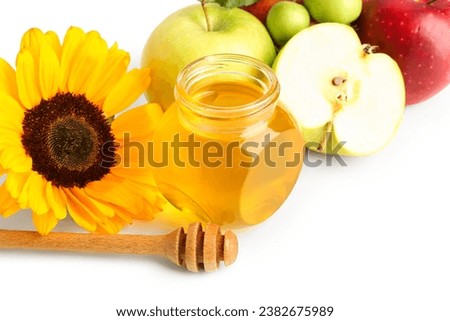Jar of honey with apples and sunflower for Rosh Hashanah celebration (Jewish New Year) on white background