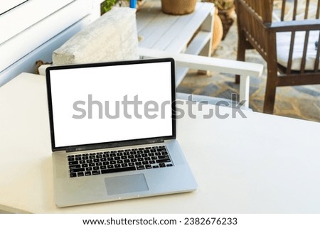 grey laptop computer open with keyboard on deckchair