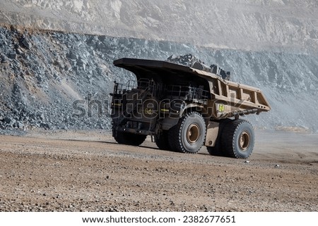  
Mining trucks come in various sizes, but some of the largest models can have payloads of over 400 tons. Their massive size allows them to transport large quantities of material efficiently.
 Royalty-Free Stock Photo #2382677651