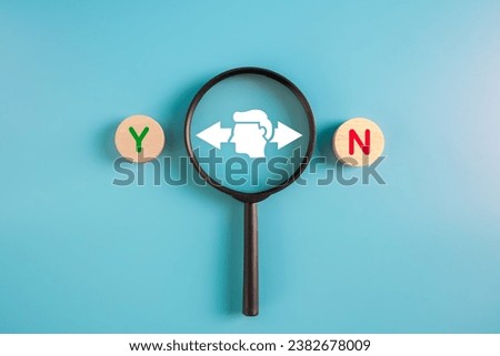 Businessman making decision for the best choice.magnifier focus man with yes and no icons on wooden circle. Royalty-Free Stock Photo #2382678009