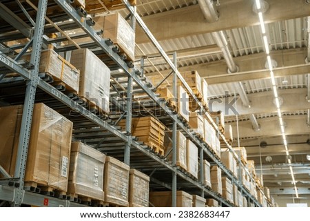 Long shelves with many cardboard boxes with product in warehouse. High quality photo