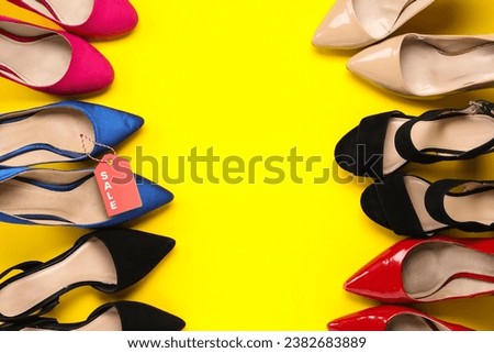 Set of different female shoes with sale tag on yellow background. Black Friday