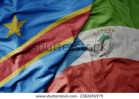 big waving national colorful flag of democratic republic of the congo and national flag of equatorial guinea . macro