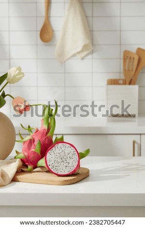 White dragon fruit on wooden cutting board. Minimalist kitchen. Dragon fruit is a plant native to dry tropical regions, so it can withstand heat and drought well.