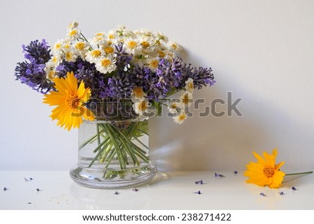Bouquet of mini chrysanthemum flowers and lavender in a vase. Floral still life.