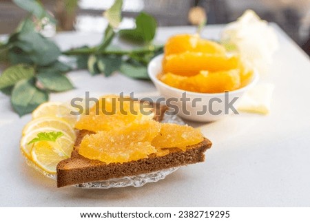 A decorated plate of food with Lemon Marmalade Toast and orange lemon 