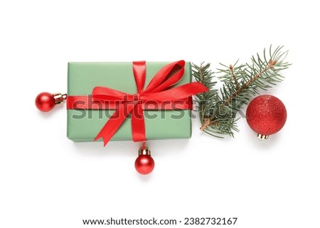 Gift box with Christmas balls and fir branch on white background