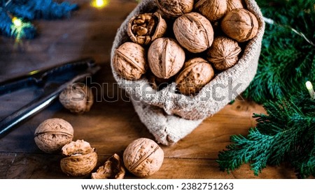 festive christmas nuts tumbling from a burlap bag