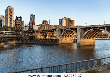 Early morning cityscape of St Paul and Twin Cities in Minnesota and Mississippi river with railroad bridge