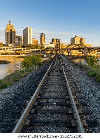 Early morning cityscape of St Paul and Twin Cities in Minnesota looking down rails of railroad bridge