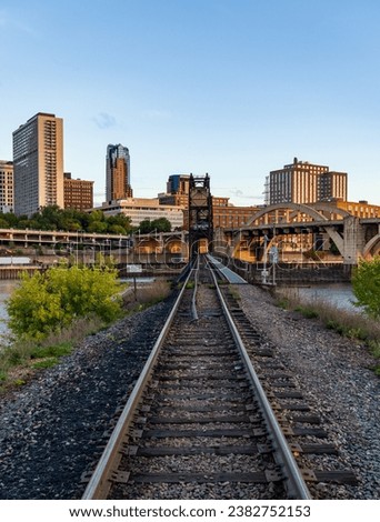 Early morning cityscape of St Paul and Twin Cities in Minnesota looking down rails of railroad bridge