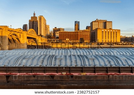 Early morning cityscape of St Paul Minnesota and Mississippi river with docked dry cargo barges