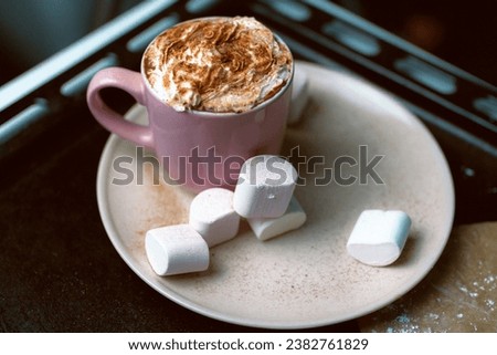 Сup of coffee with whipped cream and marshmallows. Close up photo with shallow depth of field