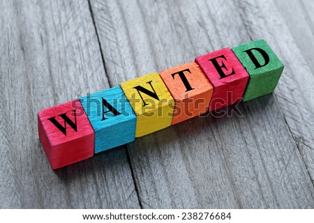 word wanted on colorful wooden cubes