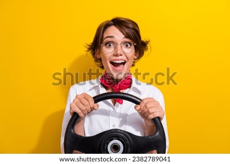 Photo of excited cheerful girl wear trendy outfit hold steering wheel driving own car weekend trip isolated on yellow color background Royalty-Free Stock Photo #2382789041