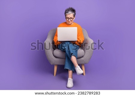 Full body photo of professional expert business worker specialist pensioner woman sit armchair coding isolated on violet color background Royalty-Free Stock Photo #2382789283