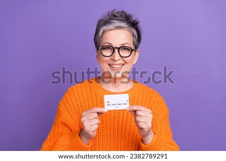 Photo of pretty sweet lady wear knitted pullover spectacles showing bank card isolated purple color background