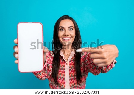 Photo portrait of pretty young girl amazed hold point telephone white display wear trendy print outfit isolated on cyan color background