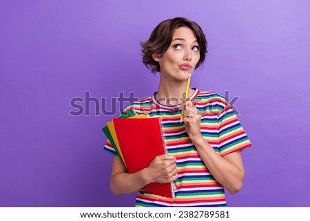 Photo of minded uncertain unsure girl in stylish striped clothes suspiciously looking empty space news isolated on purple color background