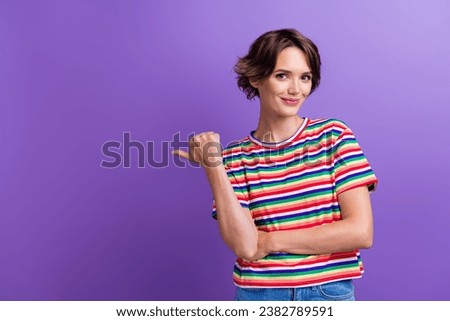 Portrait of charming attractive lady indicating finger empty blank mockup space ad ads advert isolated purple color background