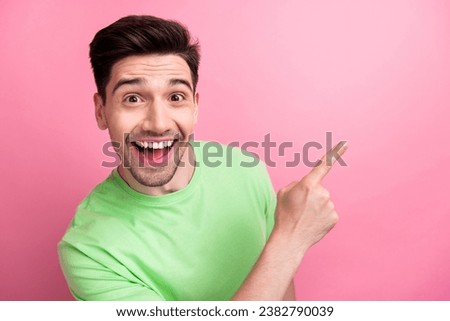 Photo of young cheerful funny guy amazed directing finger promoting new fast food restaurant delivery isolated on pink color background