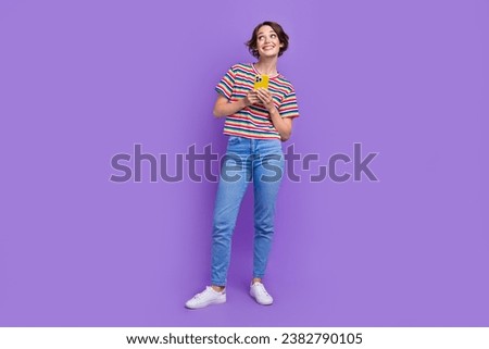 Full length photo of lovely dreamy girl blogger wear stylish clothes look up empty space banner isolated on violet color background
