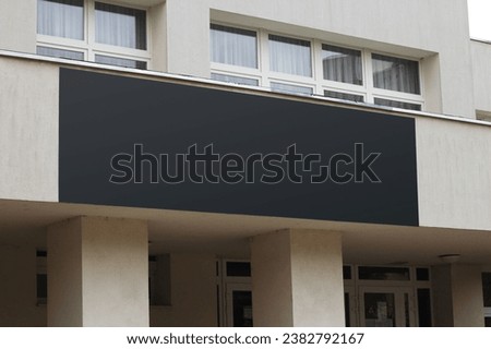 Large black billboard banner on a storefront mockup. Blank black restaurant or shop sign mock up template.