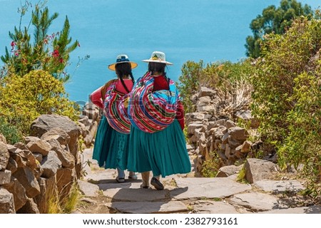 Peruvian indigenous Quechua women in traditional clothes on Taquile Island, Titicaca Lake, Peru. Royalty-Free Stock Photo #2382793161