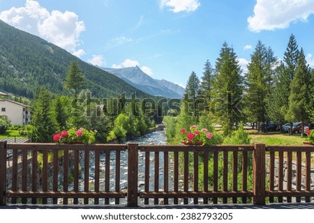 Parapet with flowers of the bridge over the stream in Lillaz. Cogne, Aosta Valley region, Italy Royalty-Free Stock Photo #2382793205