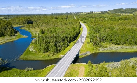 Road leading through beautiful swedish landscape with forests and lakes