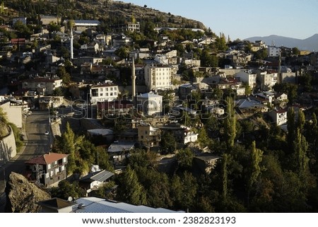 Taskent city in Konya province, Central Anatolia region, Turkey. Panoramic view from the rocks of the Taurus Mountains over the rooftops and mosques of the city.