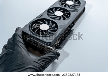 hand of a computer technician holds a modern powerful video game card