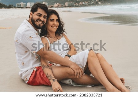 Newly married couple sitting on the beach Royalty-Free Stock Photo #2382833721