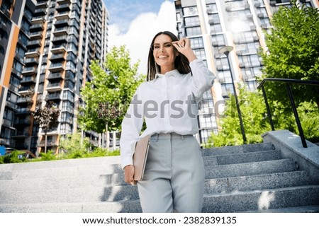 Photo of charming gorgeous shiny lady dressed stylish shirt walking outdoors spring sunny working day free time break