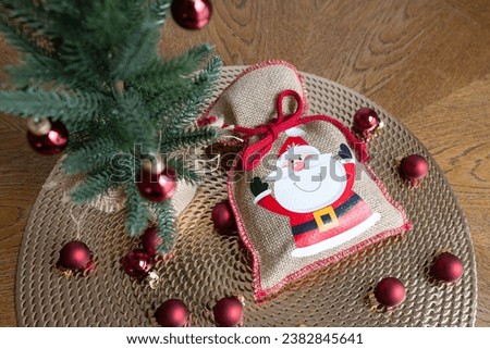 bag with a gift under the Christmas tree, New Year card