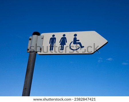 Directional sign with toilet sign for men, women and disabled