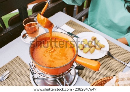 Tomato fondue is native to the Valais region and consists of tomatoes or tomato paste, traditional swiss plate Royalty-Free Stock Photo #2382847649