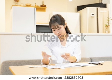 Japanese woman keeping household account book Royalty-Free Stock Photo #2382852903