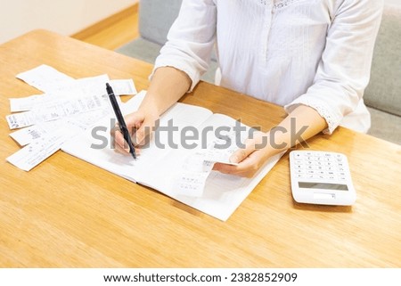 Japanese woman keeping household account book Royalty-Free Stock Photo #2382852909